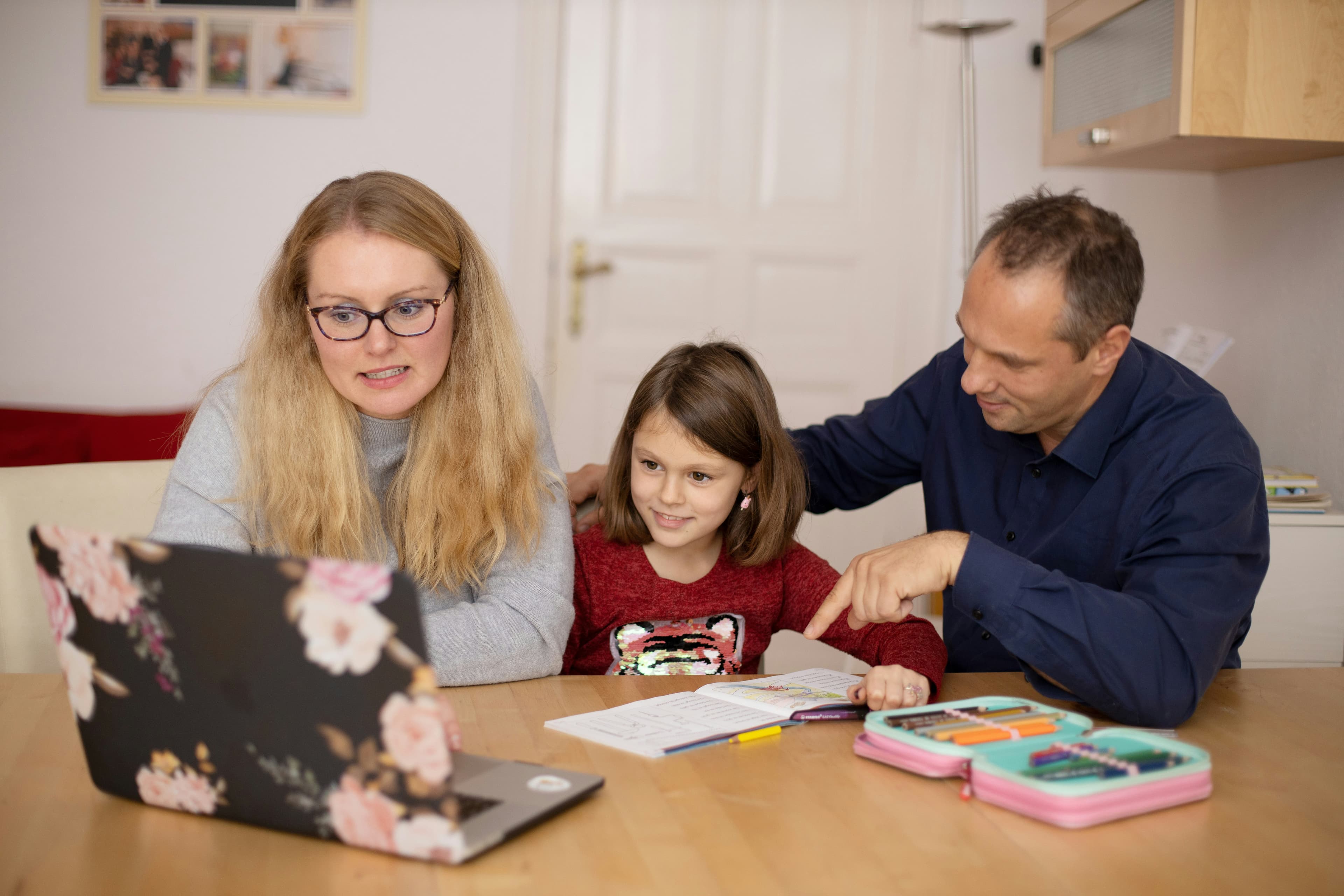 A parent and child talking through a homework problem together